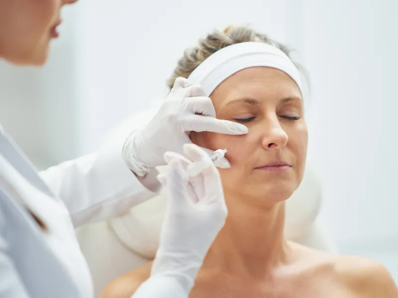 Woman receiving a cosmetic injection at a dermatology clinic